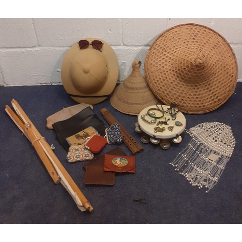 229 - A mixed vintage lot comprising costume jewellery, hats, a tambourine and wooden flute, wallets, an e... 