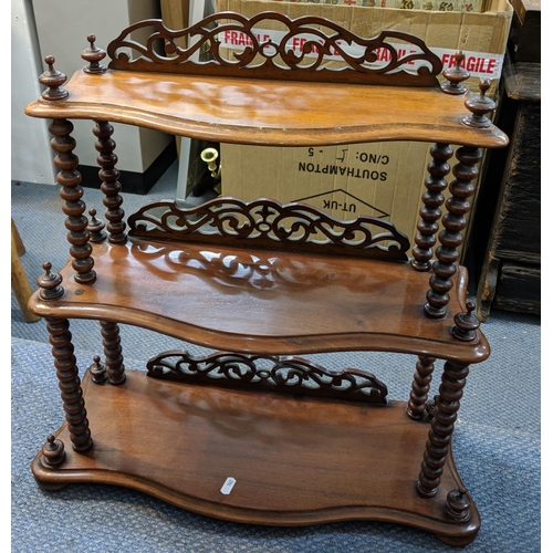 289 - A Victorian mahogany three tier graduated wall hanging shelf having pierced fretwork and bobbin turn... 