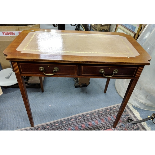 291 - An Edwardian mahogany writing table having two drawers and on tapering legs 73.5cm h x 91.5cm w Loca... 