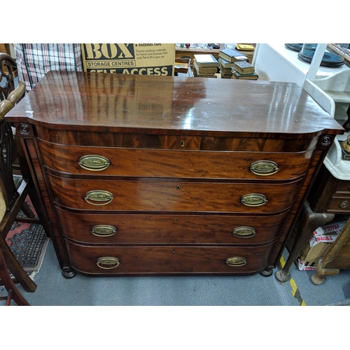 297 - An early 19th century mahogany chest of four drawers, raised on four bun shaped feet and with brass ... 