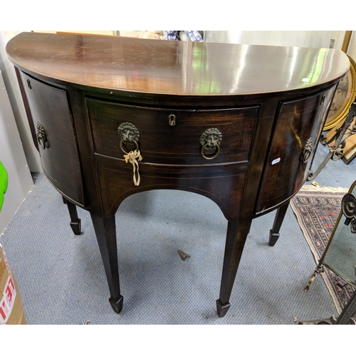 299 - An early 20th century mahogany, bow fronted cabinet, single drawer flanked by cupboard doors and on ... 