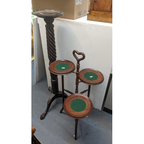 306 - A 1920's mahogany torchiere stand together with an early 20th century mahogany three tier cake stand... 