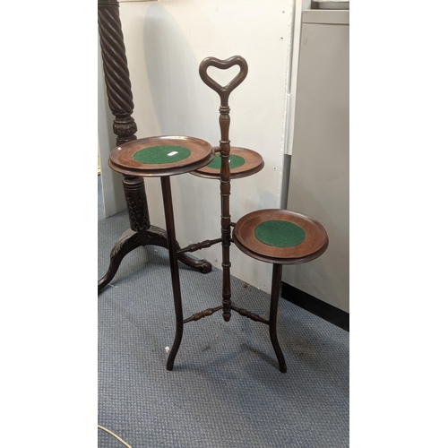 306 - A 1920's mahogany torchiere stand together with an early 20th century mahogany three tier cake stand... 