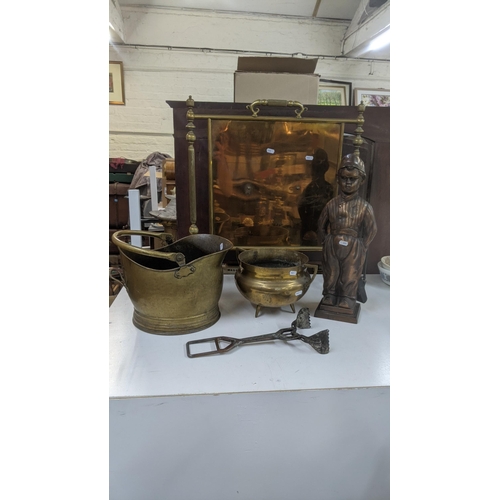 309 - Fireside items to include a brass fire screen, two brass coal buckets, cast iron boy companion set a... 