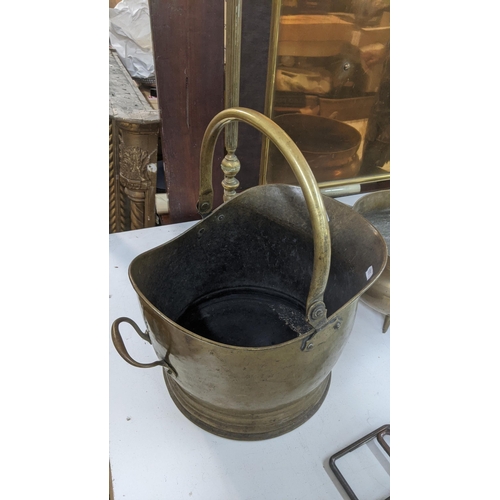 309 - Fireside items to include a brass fire screen, two brass coal buckets, cast iron boy companion set a... 