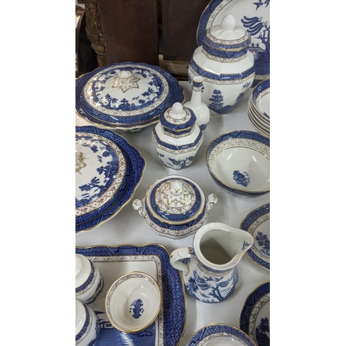 312 - A Royal Doulton Real Old Willow part dinner/tea service to include a tureen, sauce boat, cups and sa... 