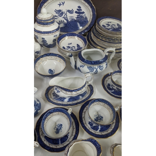 312 - A Royal Doulton Real Old Willow part dinner/tea service to include a tureen, sauce boat, cups and sa... 