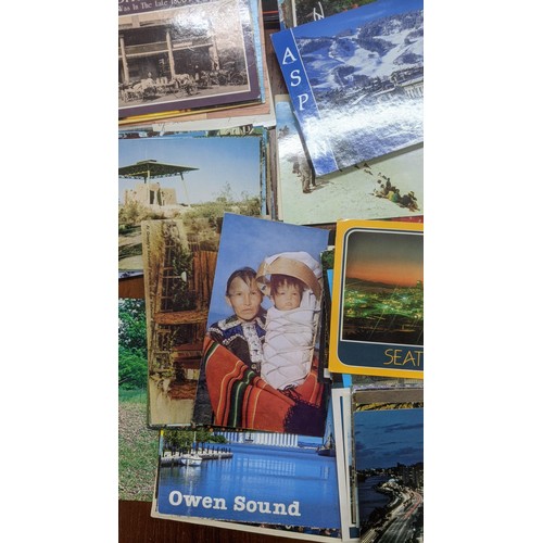 624 - Four postcard albums to include postcards from Snowdon, Thompson River and others, along with a quan... 