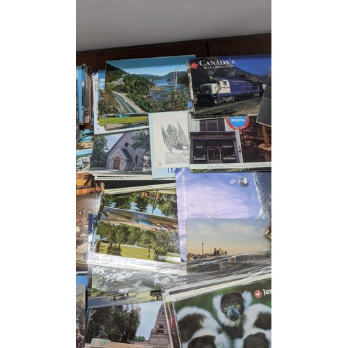 624 - Four postcard albums to include postcards from Snowdon, Thompson River and others, along with a quan... 