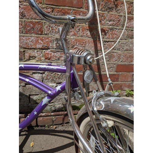 A Bratz Lowrider Purple Rain girls bicycle with banana seat, circa 1990,  Location:FOYER If there is