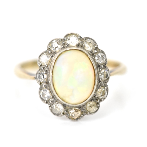 85 - A yellow and white gold opal and diamond cluster daisy ring, the central oval opal 8.8mm x 6.6mm, su... 