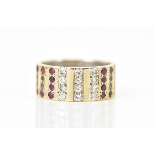 81 - A 9ct yellow and white gold ring, inset with rows of eight emeralds, sixteen rubies and twelve diamo... 