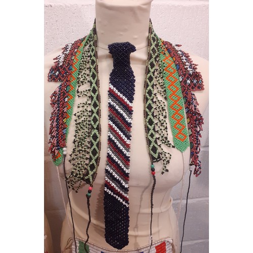 80 - A quantity of traditional ethnic beaded adornments to include Afghan belts and an African Zulu beade... 