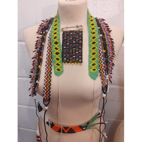 80 - A quantity of traditional ethnic beaded adornments to include Afghan belts and an African Zulu beade... 