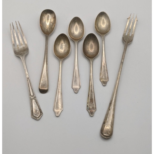12 - Silver cutlery to include a pickle fork, a set of 4 teaspoons, and others total weight 124.3g
Locati... 