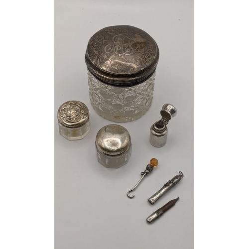 15 - Three dressing table pots having silver lids, together with a silver button hook, scent bottle and o... 