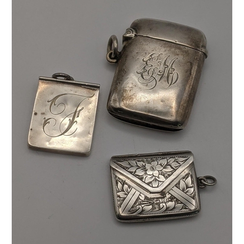 19 - Silver to include a vesta case hallmarked Birmingham 1908, together with a two stamp holders one fas... 