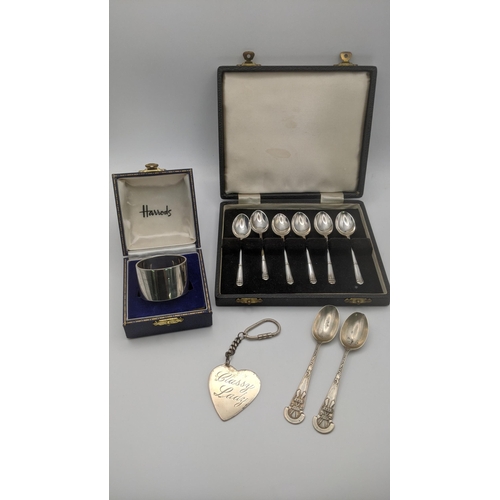 55 - Silver to include a set of six teaspoons in a fitted case, a large key ring/hand bag accessory, a th... 