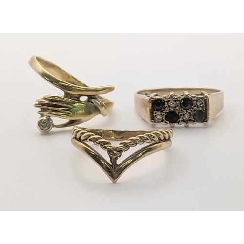 62 - Three gold ladies rings to include a 14ct gold and diamond ring fashioned as a hand, a 9ct gold retr... 