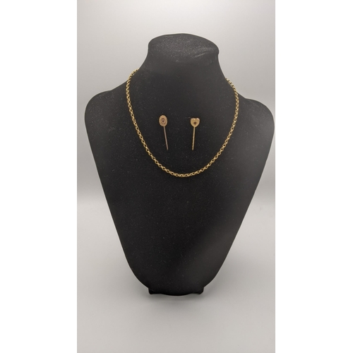 67 - A 9ct gold chain, 39cm l, together with two 9ct gold stick pins, one set with a ruby and the other a... 