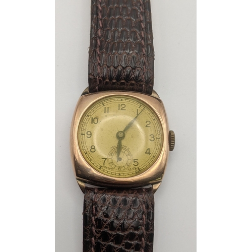 75 - A 9ct gold gent's manual-wind wristwatch on a brown leather strap, along with a black leather strap ... 