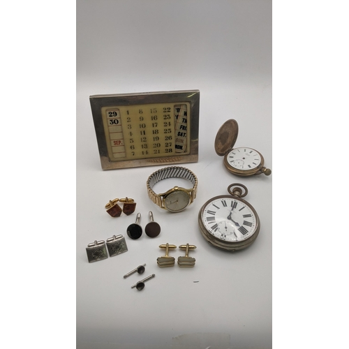 77 - A mixed lot to include a silver framed calendar hallmarked London 1920, together with medal and wris... 