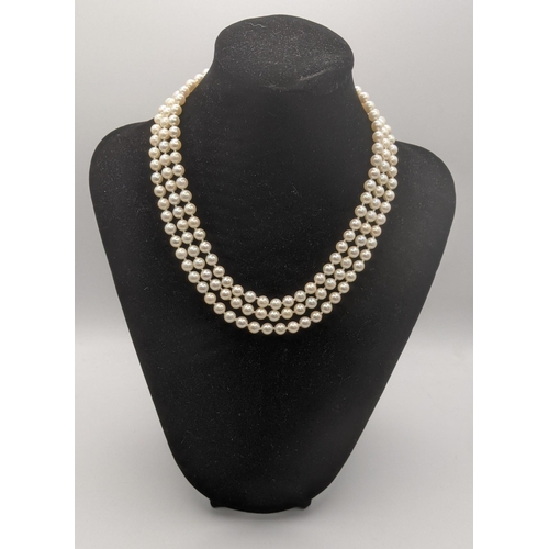 9 - A triple strand pearl necklace having a 9ct gold clasp fashioned as a flower 
Location: CAB
If there... 