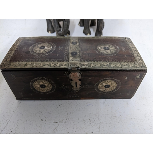 295 - A hardwood trinket box inlaid and mounted in white metal, and two pairs of carved wooden elephants L... 