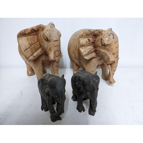 295 - A hardwood trinket box inlaid and mounted in white metal, and two pairs of carved wooden elephants L... 