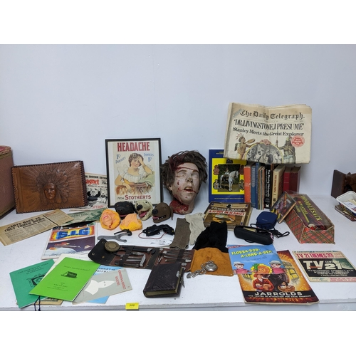 306 - A mixed lot of ephemera, books, TV related and props department items to include a severed head, 33r... 