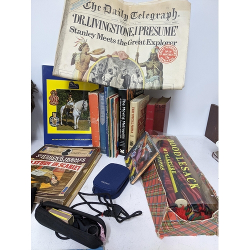 306 - A mixed lot of ephemera, books, TV related and props department items to include a severed head, 33r... 