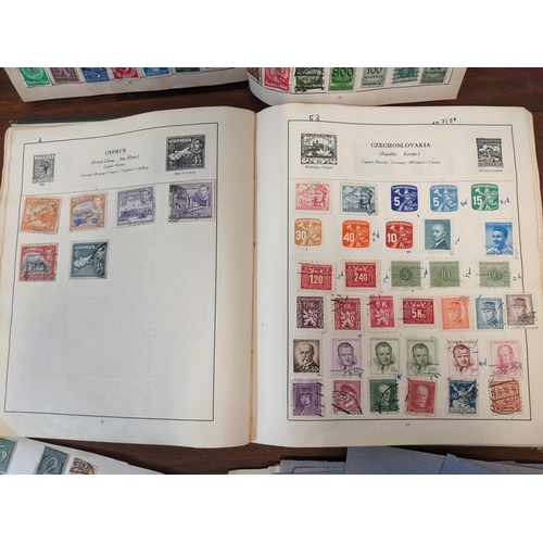 314 - Two early to mid century stamp albums and various loose stock pages containing world stamps, Chinese... 