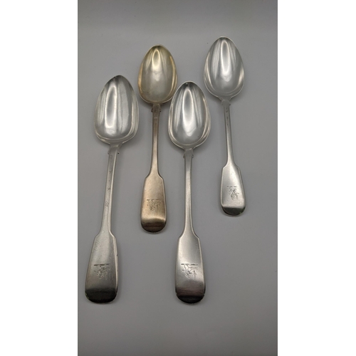 105 - Silver fiddle pattern serving spoons, to include three English spoons and one Irish spoon, total wei... 