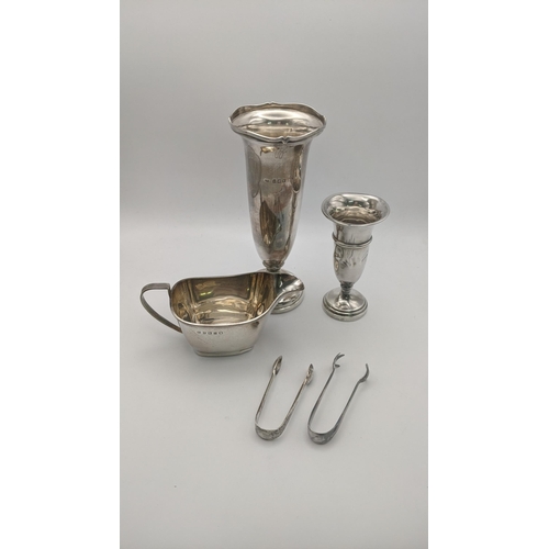 114 - Silver to include a weighted vase, a smaller weighted vase A/F a cream jug and sugar tongs, total we... 