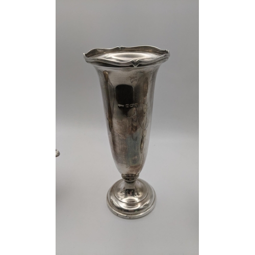 114 - Silver to include a weighted vase, a smaller weighted vase A/F a cream jug and sugar tongs, total we... 