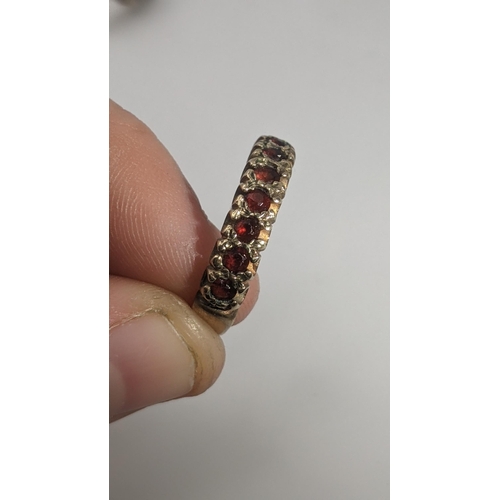 155 - Three 9ct gold ladies rings to include two set with garnets, and the other set with paste stones, to... 