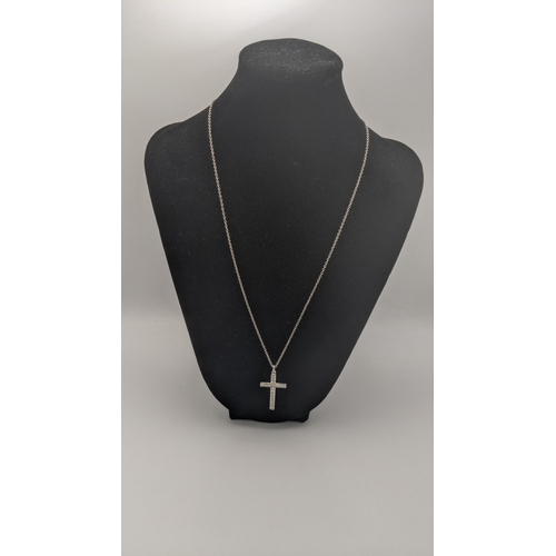 165 - A white gold and diamond cross pendant on a white gold necklace, both tested as 18ct gold, total wei... 
