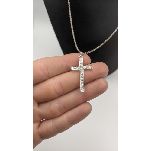 165 - A white gold and diamond cross pendant on a white gold necklace, both tested as 18ct gold, total wei... 