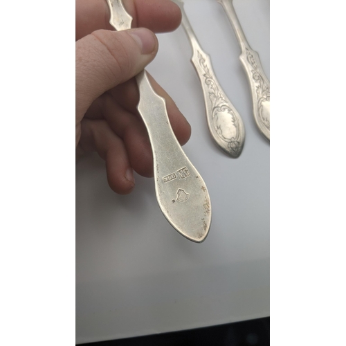 174 - A set of six white metal, possibly Romanian, teaspoons stamped 750 having engraved floral terminals,... 