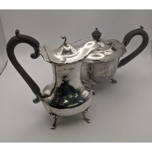 175 - A silver Goldsmiths and Silversmith Co Ltd hot water jug hallmarked London 1902 on four feet 318g, a... 