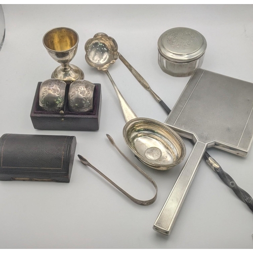 183 - Silver to include a pair of floral engraved napkin rings in a fitted case A/F, a sugar sifter, a tod... 