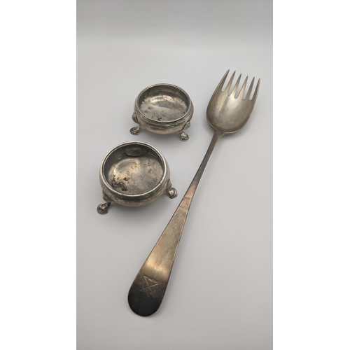 185 - Silver to include a Georgian salad server decorated with family crest to the terminal, together with... 