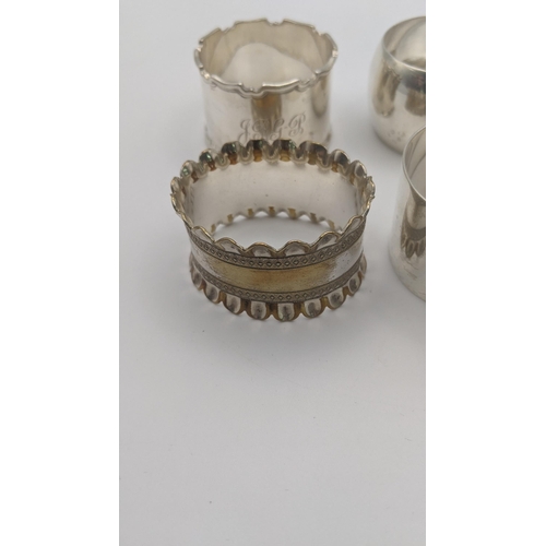 209 - A group of four different napkin rings to include one inscribed April 30th 1898, and others, total w... 