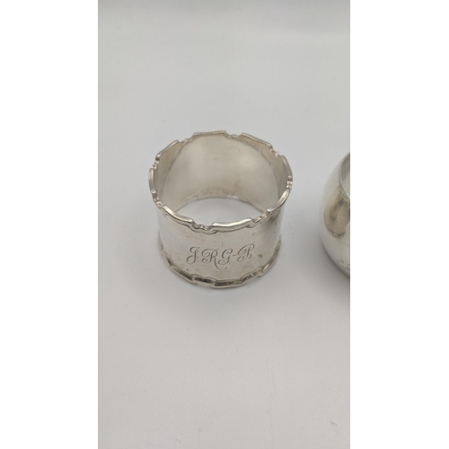 209 - A group of four different napkin rings to include one inscribed April 30th 1898, and others, total w... 