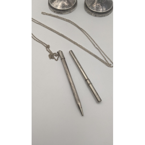 210 - Silver to include a pair of weighted candlesticks, a life long propelling pencil and a lead case wit... 