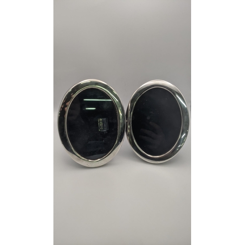 213 - A pair of oval shaped silver photograph frames made by Carr's of Sheffield retailed by Asprey London... 