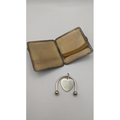 230 - A silver cigarette case having a machine design and a gilt interior 87.8g together with a white meta... 