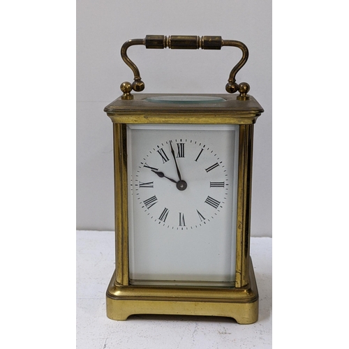 273 - An early 20th century brass carriage clock having a white enamel dial with Roman numerals, 14.5h inc... 