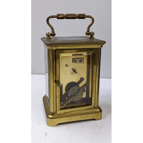 273 - An early 20th century brass carriage clock having a white enamel dial with Roman numerals, 14.5h inc... 