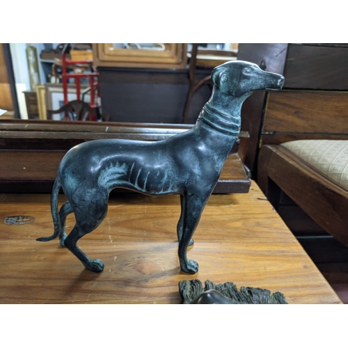 369 - Metalware to include a 19th century money bank, two bronze greyhounds and a composition greyhound Lo... 